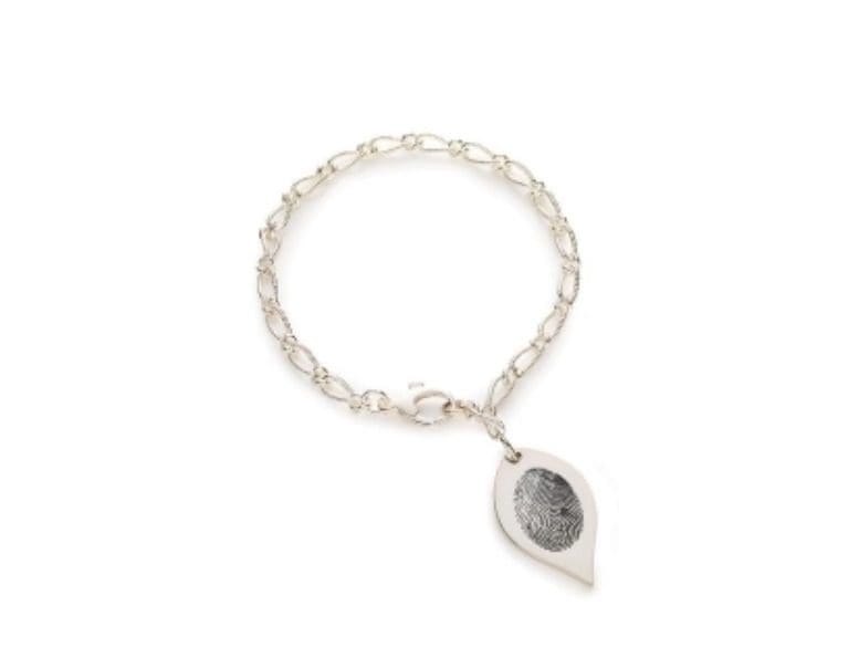 A silver chain bracelet with a leaf shaped charm.