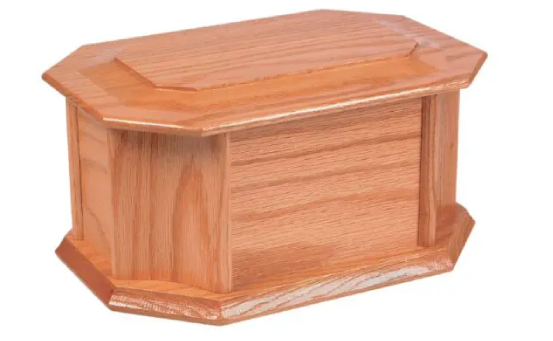 A wooden casket with no lid on top of it.