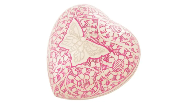 A pink heart shaped box with a butterfly on it.